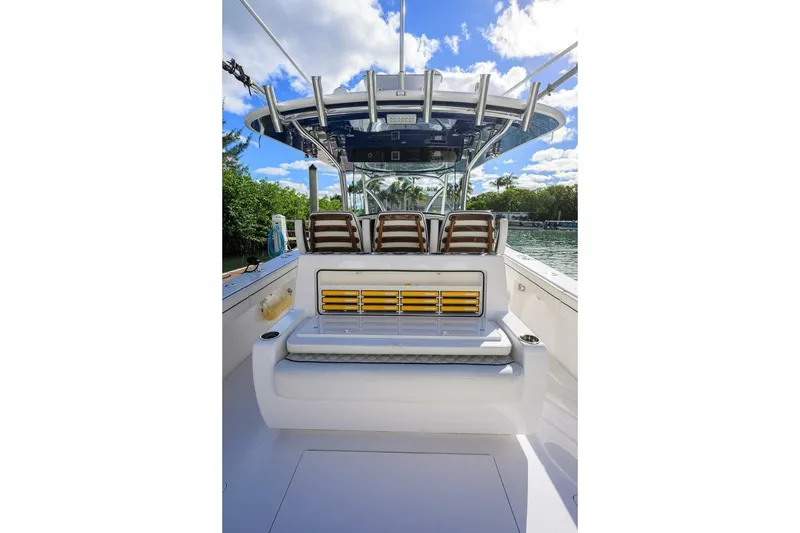 Slide: The Image of 2025 Valhalla Boatworks V-41 interior with seating and helm, under clear blue sky. - 14