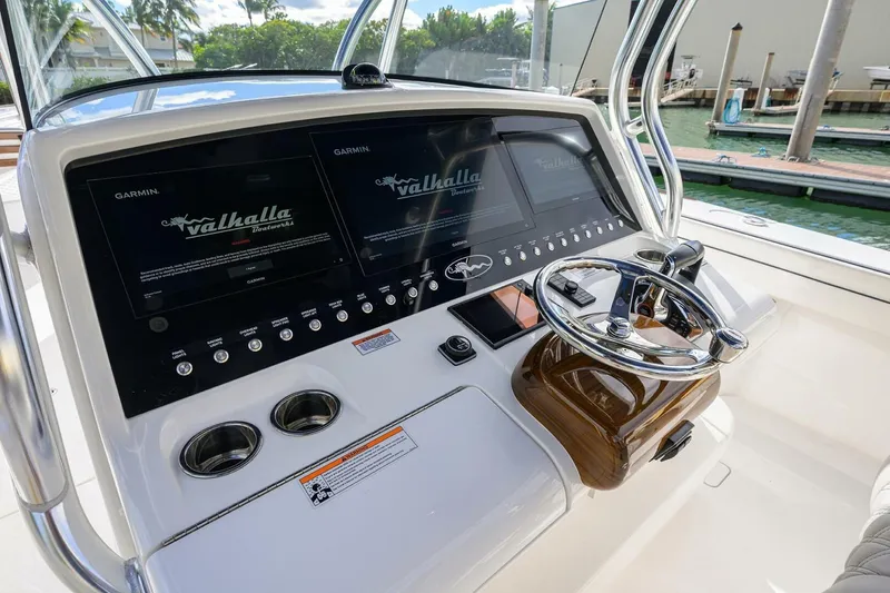 Slide: The Image of 2025 Valhalla Boatworks V-41 helm with dual Garmin displays and sleek steering wheel. - 27