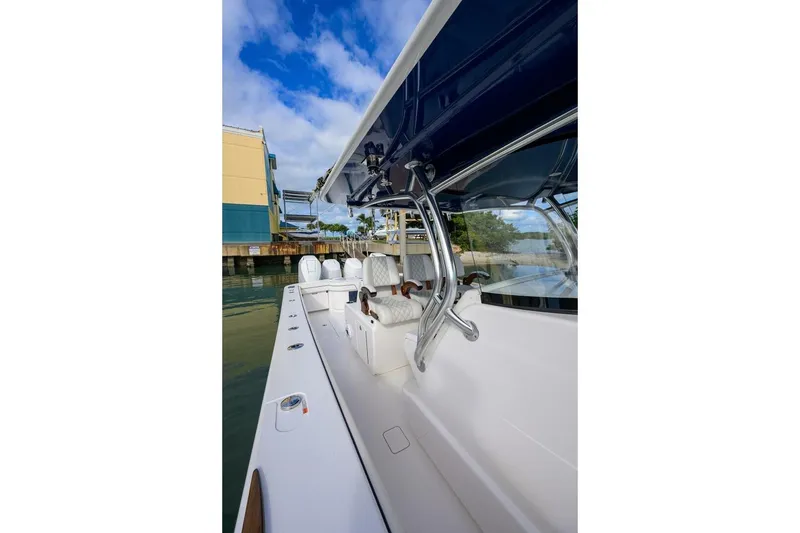 Slide: The Image of 2025 Valhalla Boatworks V-41, sleek design, docked in marina under blue sky. - 30