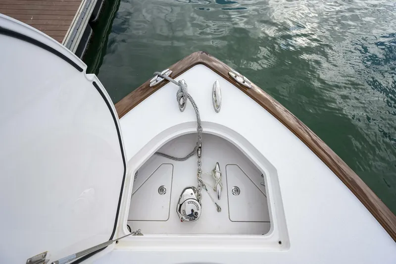 Slide: The Image of 2025 Valhalla Boatworks V-41 bow with anchor and chain, docked on calm water. - 41