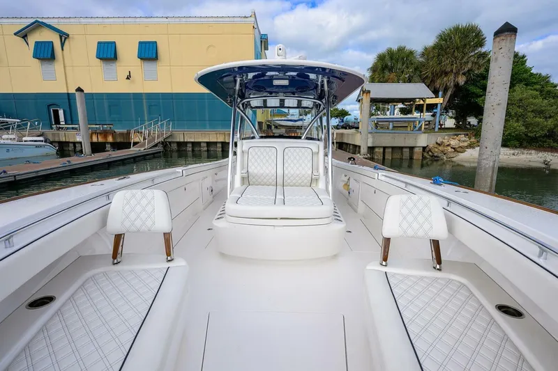 Slide: The Image of 2025 Valhalla Boatworks V-41 with luxurious seating at a marina dock. - 43