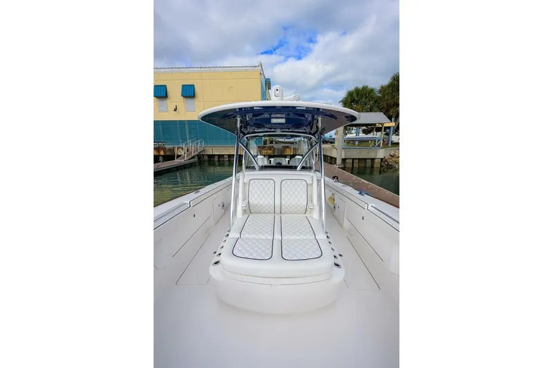 Slide: The Image of 2025 Valhalla Boatworks V-41, sleek white design, docked at marina under cloudy sky. - 44