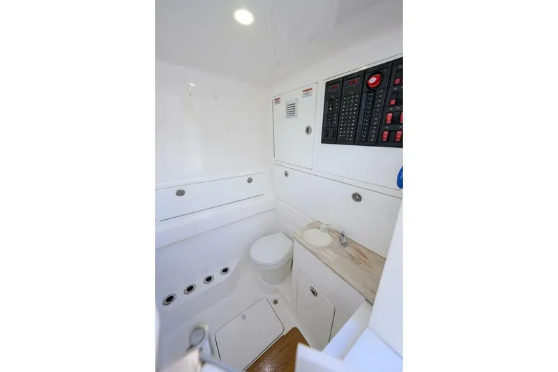 Slide: The Image of 2025 Valhalla Boatworks V-41 interior with control panel and compact bathroom. - 48