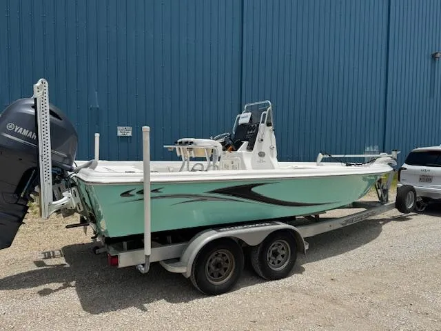 Slide: The Image of 2016 Blue Wave 2200 PureBay boat on trailer, parked near blue building. - 11