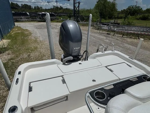 Slide: The Image of 2016 Blue Wave 2200 PureBay boat with 150 HP engine, parked outdoors. - 14