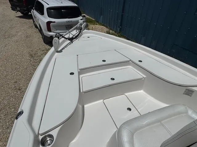 Slide: The Image of 2016 Blue Wave 2200 PureBay boat with white deck and storage compartments. - 18