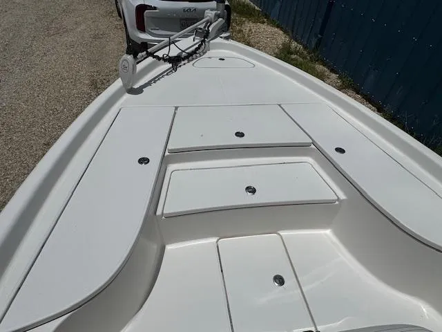 Slide: The Image of 2016 Blue Wave 2200 PureBay boat deck with storage compartments and trolling motor. - 19