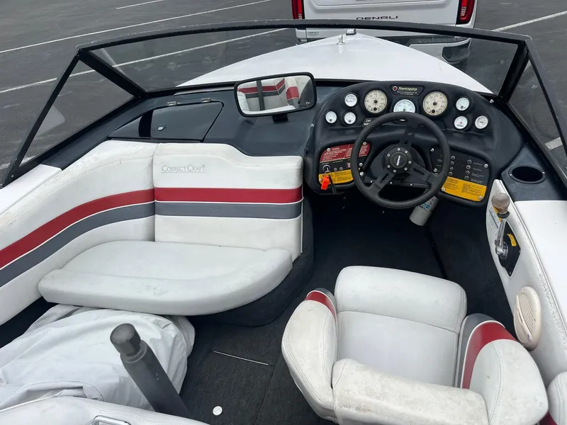 Slide: The Image of 1993 Correct Craft Ski Nautique boat interior with steering wheel and dashboard controls. - 7