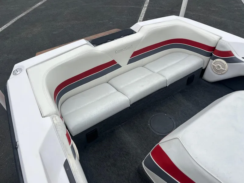 Slide: The Image of 1993 Correct Craft Ski Nautique interior with white, red, and gray seating. - 8