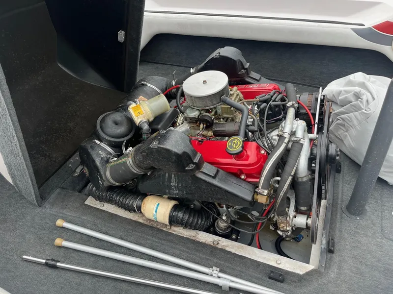 Slide: The Image of 1993 Correct Craft Ski Nautique engine compartment with visible components and accessories. - 9