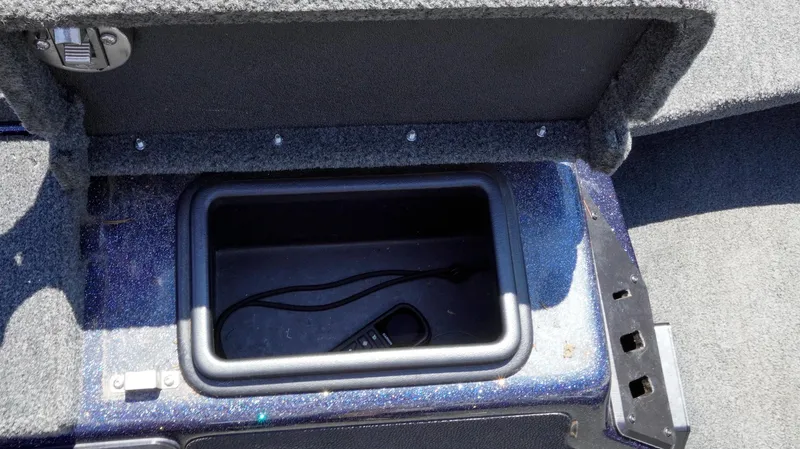 Slide: The Image of 2021 Skeeter ZX200 storage compartment with open lid, showing interior space and carpeted surroundings. - 14