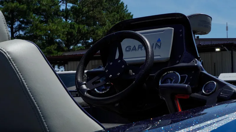 Slide: The Image of 2021 Skeeter ZX200 boat dashboard with Garmin navigation system and steering wheel. - 21