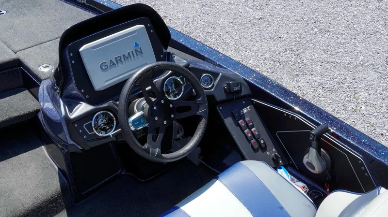 Slide: The Image of 2021 Skeeter ZX200 boat dashboard with Garmin display and steering wheel. - 22