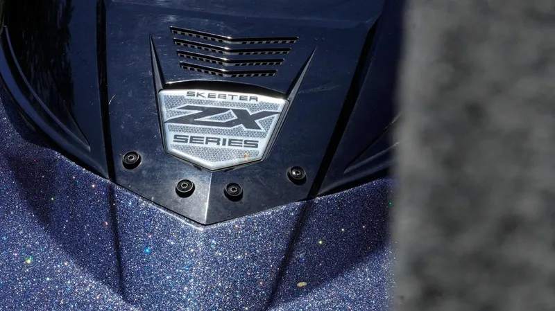 Slide: The Image of Close-up of 2021 Skeeter ZX200 boat badge on glittery surface. - 25