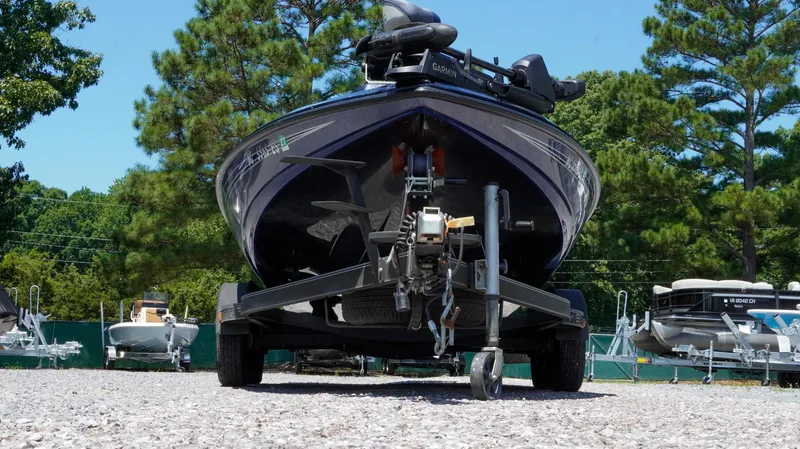 Slide: The Image of 2021 Skeeter ZX200 boat on trailer in outdoor storage lot, surrounded by trees. - 33