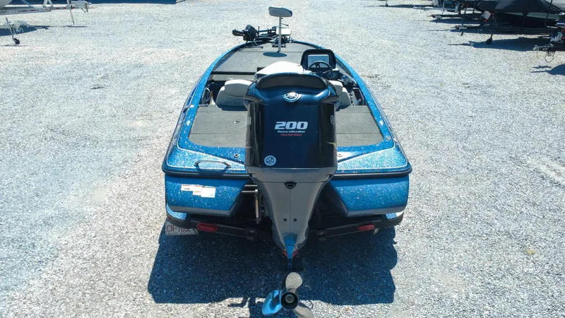 Slide: The Image of 2021 Skeeter ZX200 boat with Yamaha 200 engine, parked on gravel. - 4