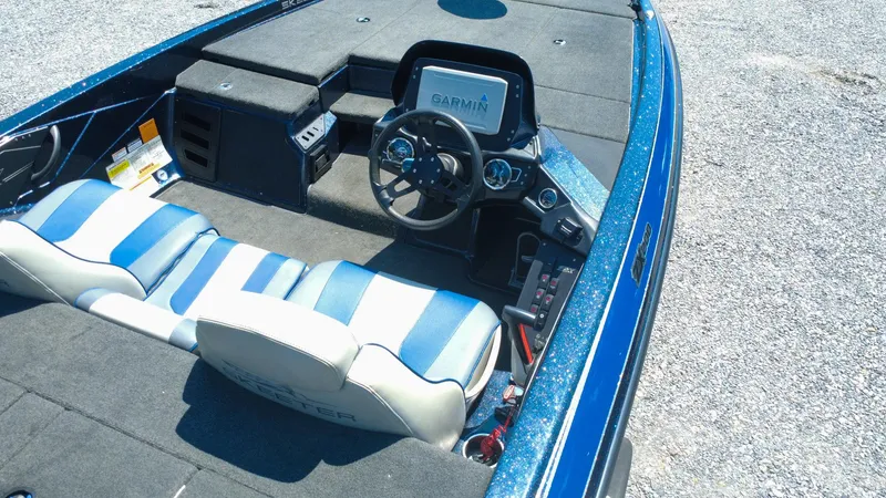 Slide: The Image of 2021 Skeeter ZX200 boat interior with blue-striped seats and Garmin navigation system. - 5