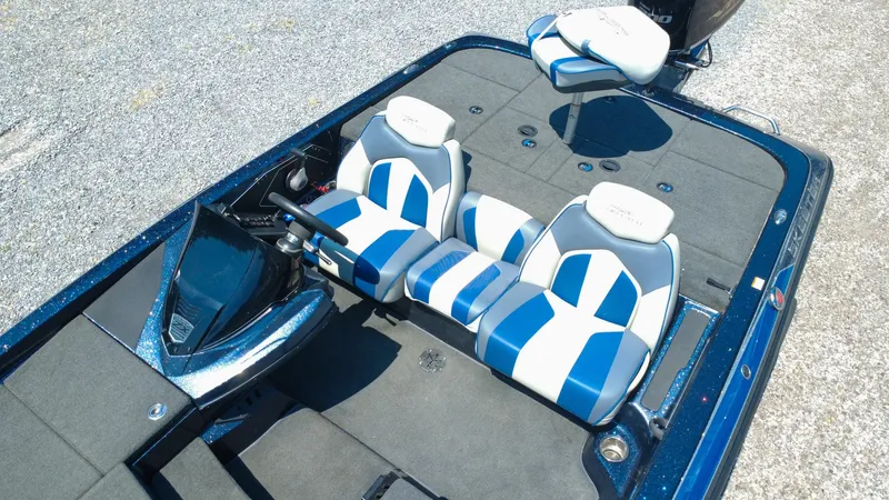 Slide: The Image of 2021 Skeeter ZX200 boat interior with blue and white seats, steering console, and fishing platform. - 6