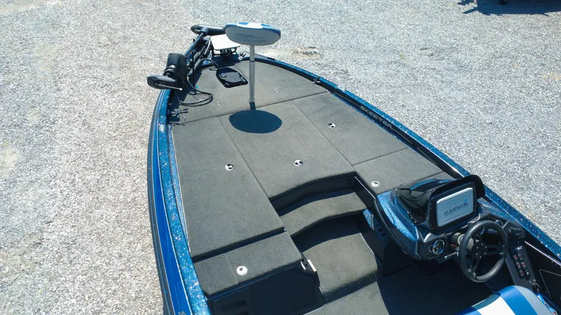 Slide: The Image of 2021 Skeeter ZX200 boat interior with Garmin system and trolling motor on a gravel surface. - 7