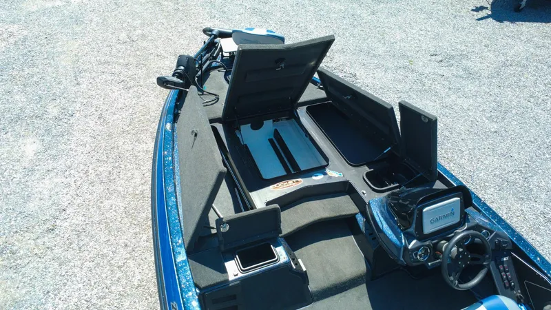 Slide: The Image of 2021 Skeeter ZX200 boat interior with open storage compartments and Garmin navigation system. - 8
