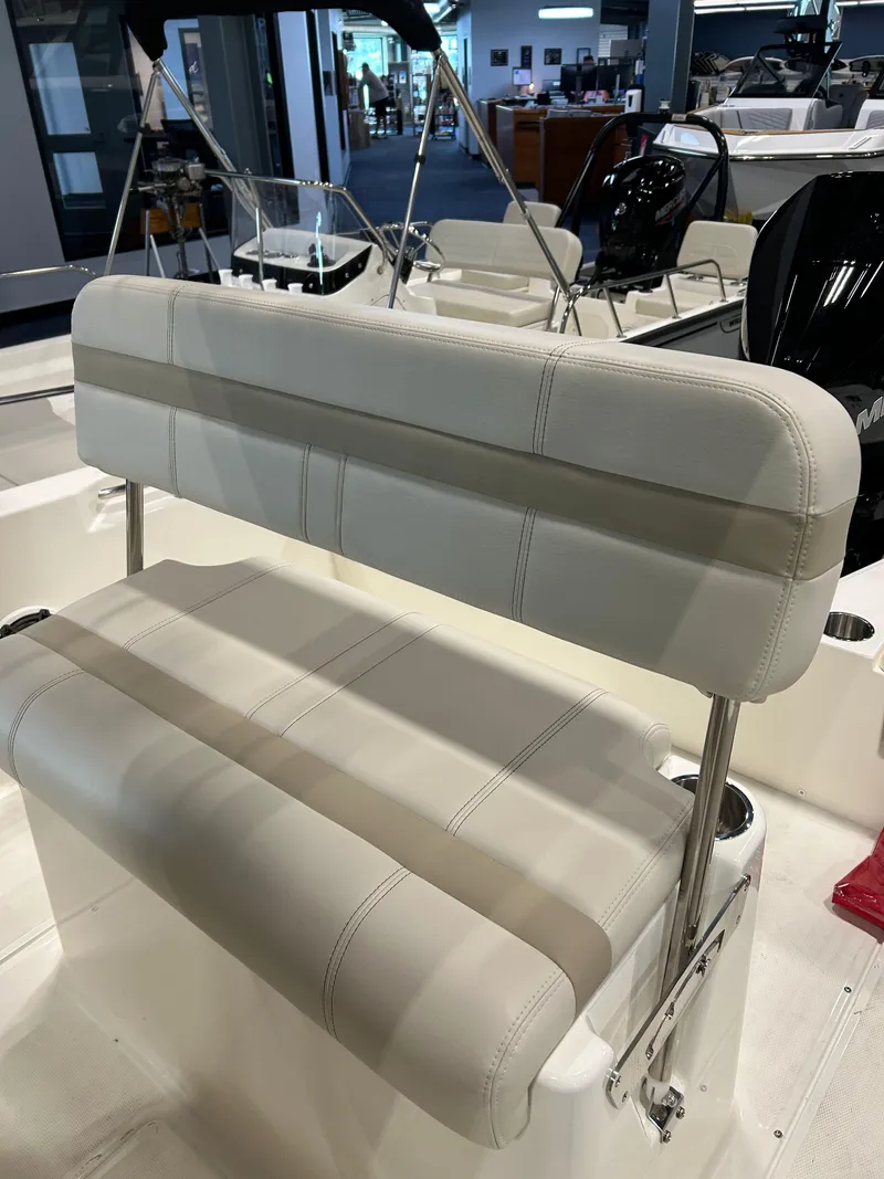 Slide: The Image of 2025 Boston Whaler 220 Dauntless boat seat, white upholstery, showroom display. - 4