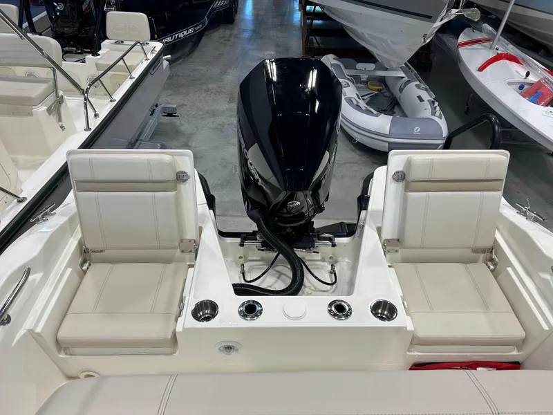 Slide: The Image of 2025 Boston Whaler 220 Dauntless boat interior with seating and outboard motor. - 7