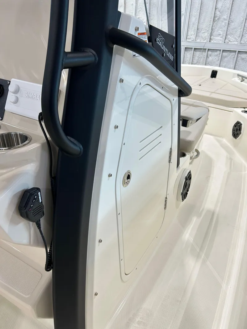 Slide: The Image of 2025 Boston Whaler 220 Dauntless interior, featuring console and storage compartment. - 8