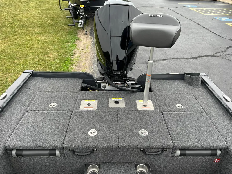 Slide: The Image of 2026 Lund 1875 Pro-V Bass XS boat deck with motor and seating. - 10