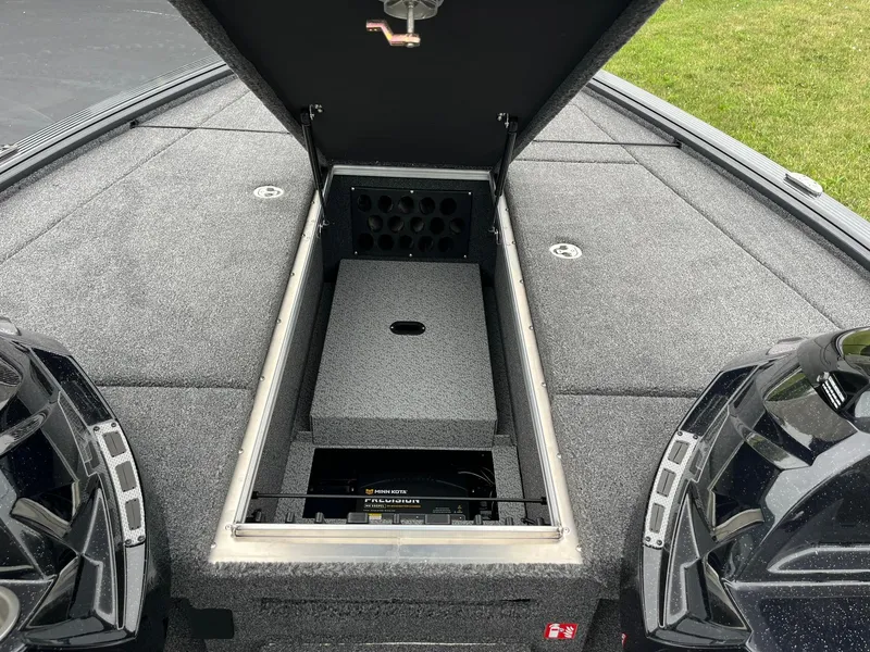 Slide: The Image of 2026 Lund 1875 Pro-V Bass XS boat storage compartment with open lid, showcasing interior features. - 11