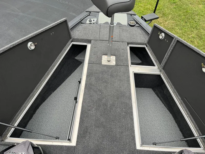 Slide: The Image of 2026 Lund 1875 Pro-V Bass XS boat interior with open storage compartments and seating. - 12