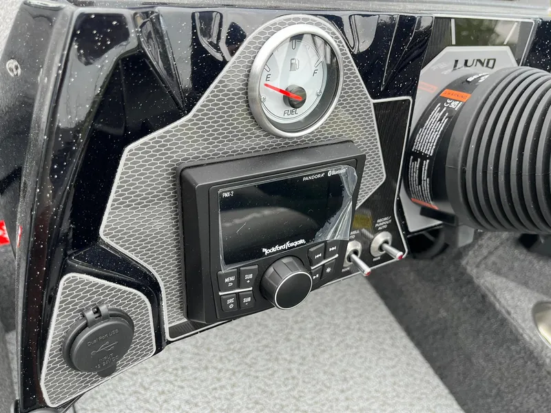 Slide: The Image of Dashboard of 2026 Lund 1875 Pro-V Bass XS with fuel gauge and audio controls. - 14