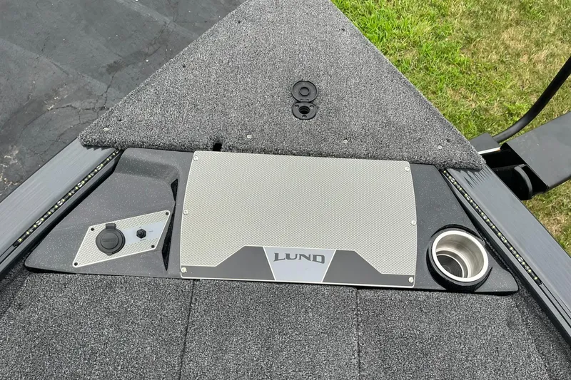 Slide: The Image of 2026 Lund 1875 Pro-V Bass XS boat deck with storage and cup holder. - 17