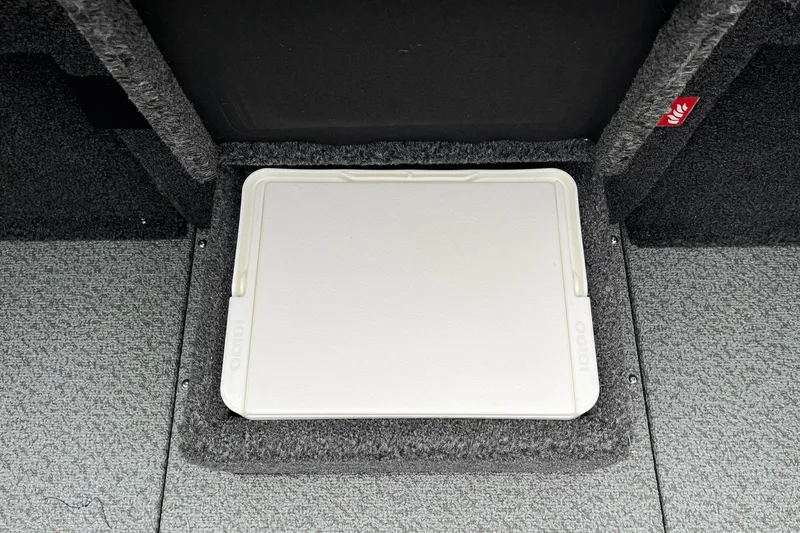 Slide: The Image of 2026 Lund 1875 Pro-V Bass XS boat storage compartment with carpeted interior. - 19