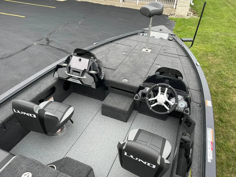Slide: The Image of 2026 Lund 1875 Pro-V Bass XS boat interior with dual seats and steering console. - 5