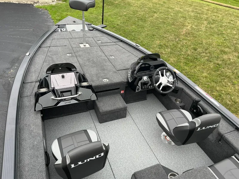 Slide: The Image of 2026 Lund 1875 Pro-V Bass XS boat interior with steering console and seating. - 6