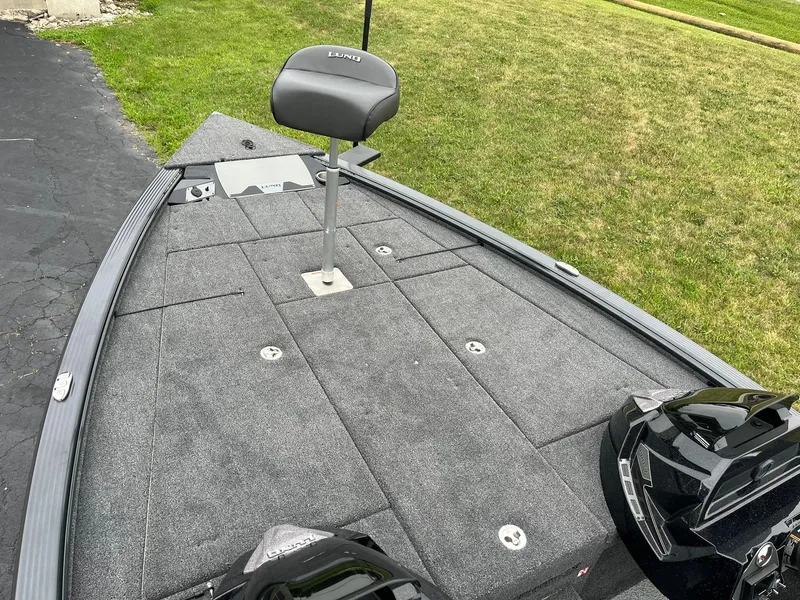 Slide: The Image of 2026 Lund 1875 Pro-V Bass XS boat deck with seat, on grass. - 7