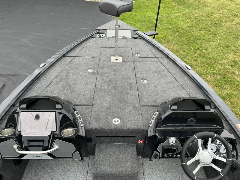 Slide: The Image of 2026 Lund 1875 Pro-V Bass XS boat interior with dual consoles and steering wheel. - 8