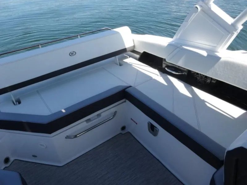 Slide: The Image of 2024 Cobalt R6 boat interior with sleek seating and modern design on calm water. - 13