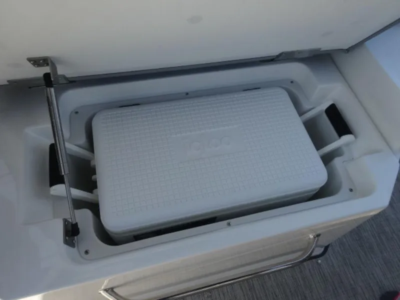 Slide: The Image of Built-in cooler compartment in 2024 Cobalt R6 boat, featuring an Igloo cooler. - 16