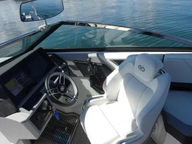 Slide: The Image of 2024 Cobalt R6 boat interior with sleek steering wheel and luxurious white seating. - 21