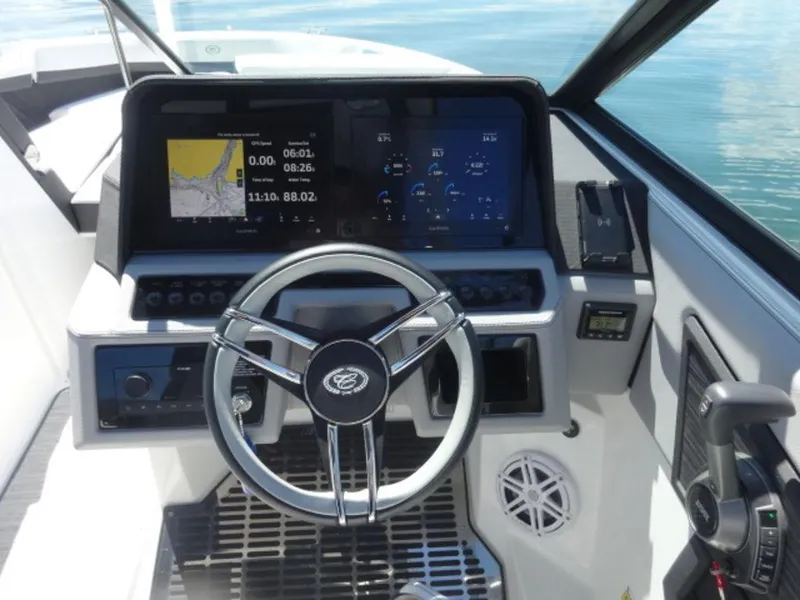 Slide: The Image of 2024 Cobalt R6 boat dashboard with steering wheel, digital displays, and control panel. - 22
