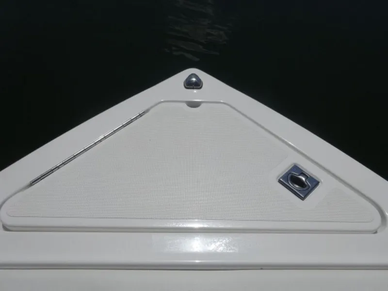 Slide: The Image of 2024 Cobalt R6 boat bow with sleek white design and metal fixtures. - 25