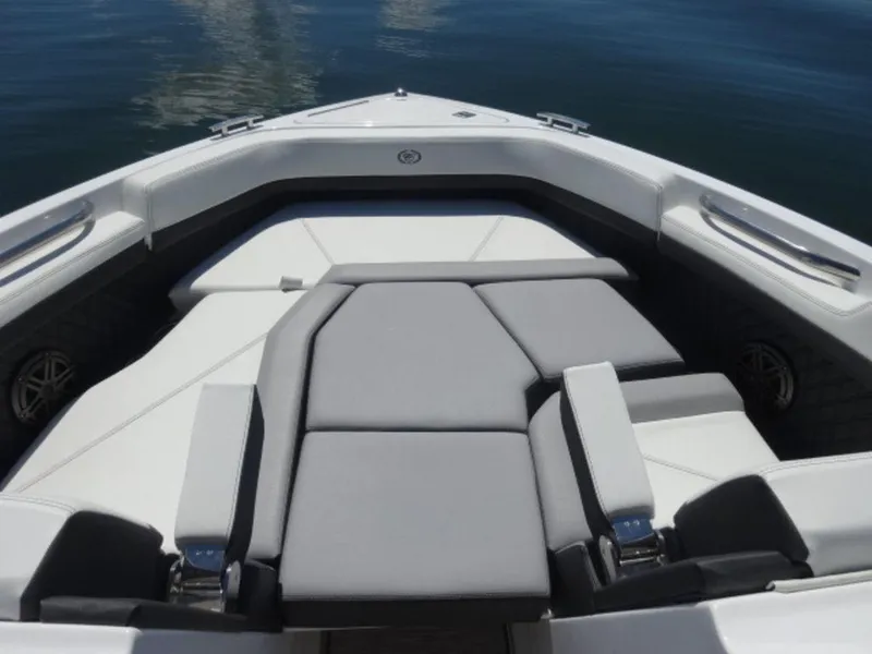Slide: The Image of 2024 Cobalt R6 boat interior with gray seating and sleek design on calm water. - 27