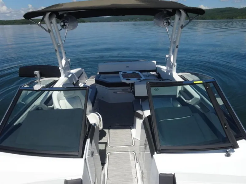 Slide: The Image of 2024 Cobalt R6 boat interior with open deck, sleek design, and calm water backdrop. - 30