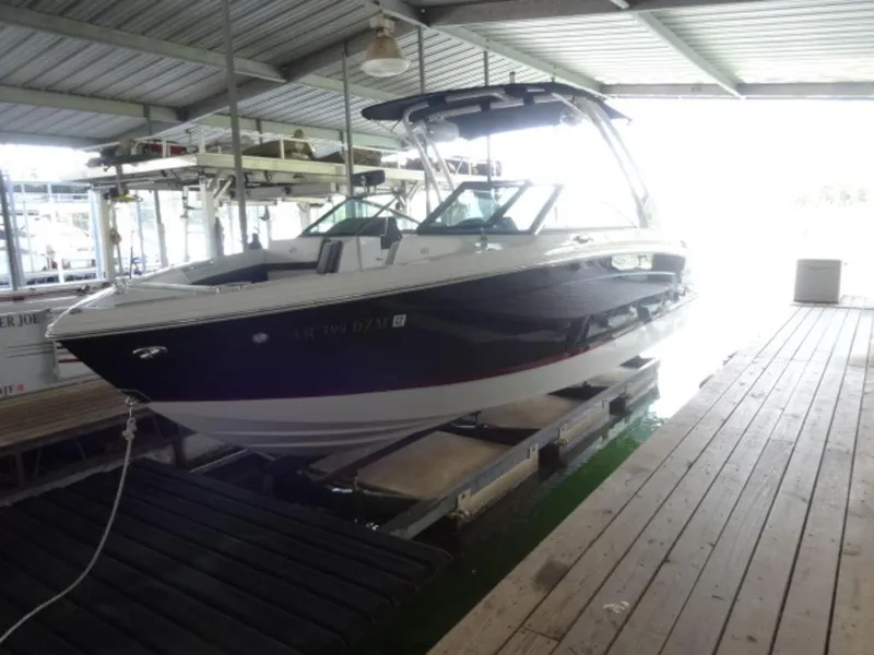 Slide: The Image of 2024 Cobalt R6 boat docked in a covered marina. - 5