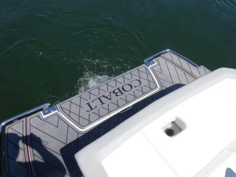 Slide: The Image of 2024 Cobalt R6 boat swim platform on water, showcasing brand logo and design. - 6