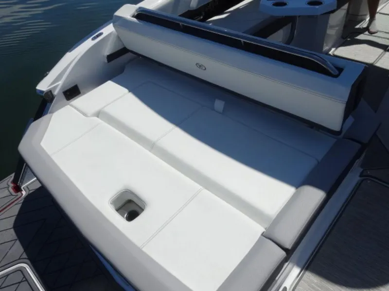 Slide: The Image of 2024 Cobalt R6 boat with white cushioned seating and cup holders on deck. - 8