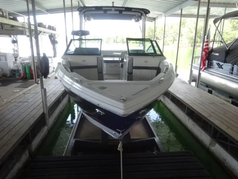 Slide: The Image of 2024 Cobalt R6 boat docked in a covered marina, front view. - 9