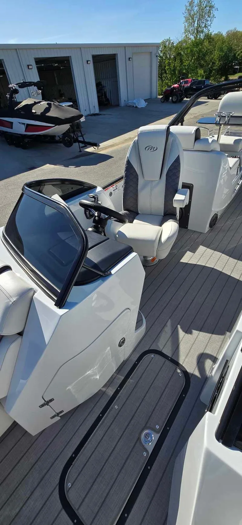 Slide: The Image of 2025 Manitou 25 LX SRW boat interior with sleek design and modern controls. - 12