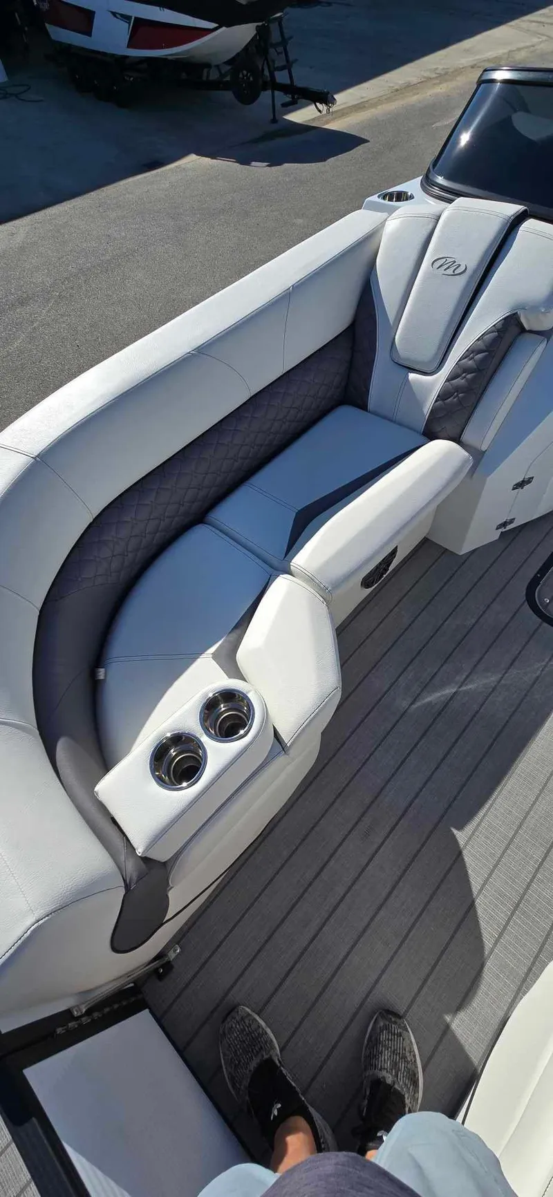 Slide: The Image of 2025 Manitou 25 LX SRW boat interior with luxurious seating and cup holders. - 15